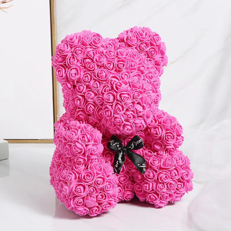 a pink teddy bear sitting on a white background 