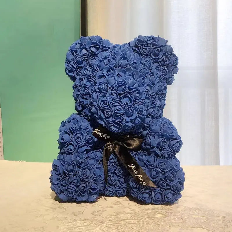 a blue teddy bear sitting on a table 
