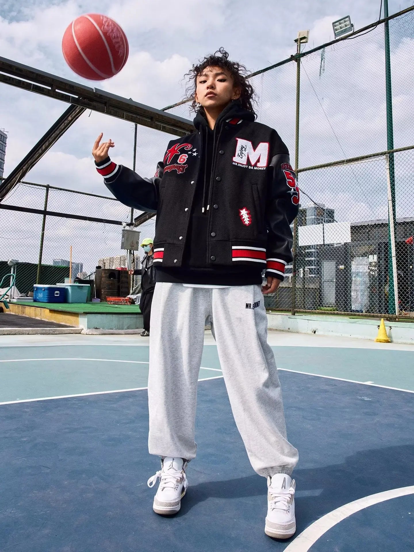 a man standing on a baseball field holding a ball 